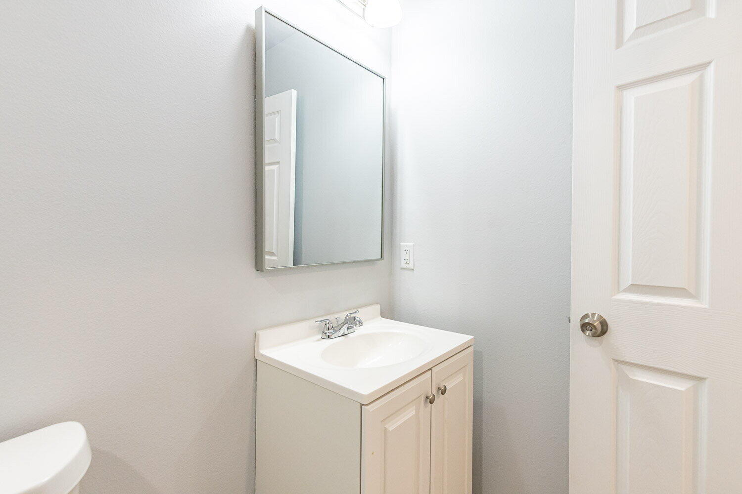 5517 Kemper Street, Unit A Lubbock, TX 79416 - Photo 22 of 25 a bathroom with a sink and a mirror