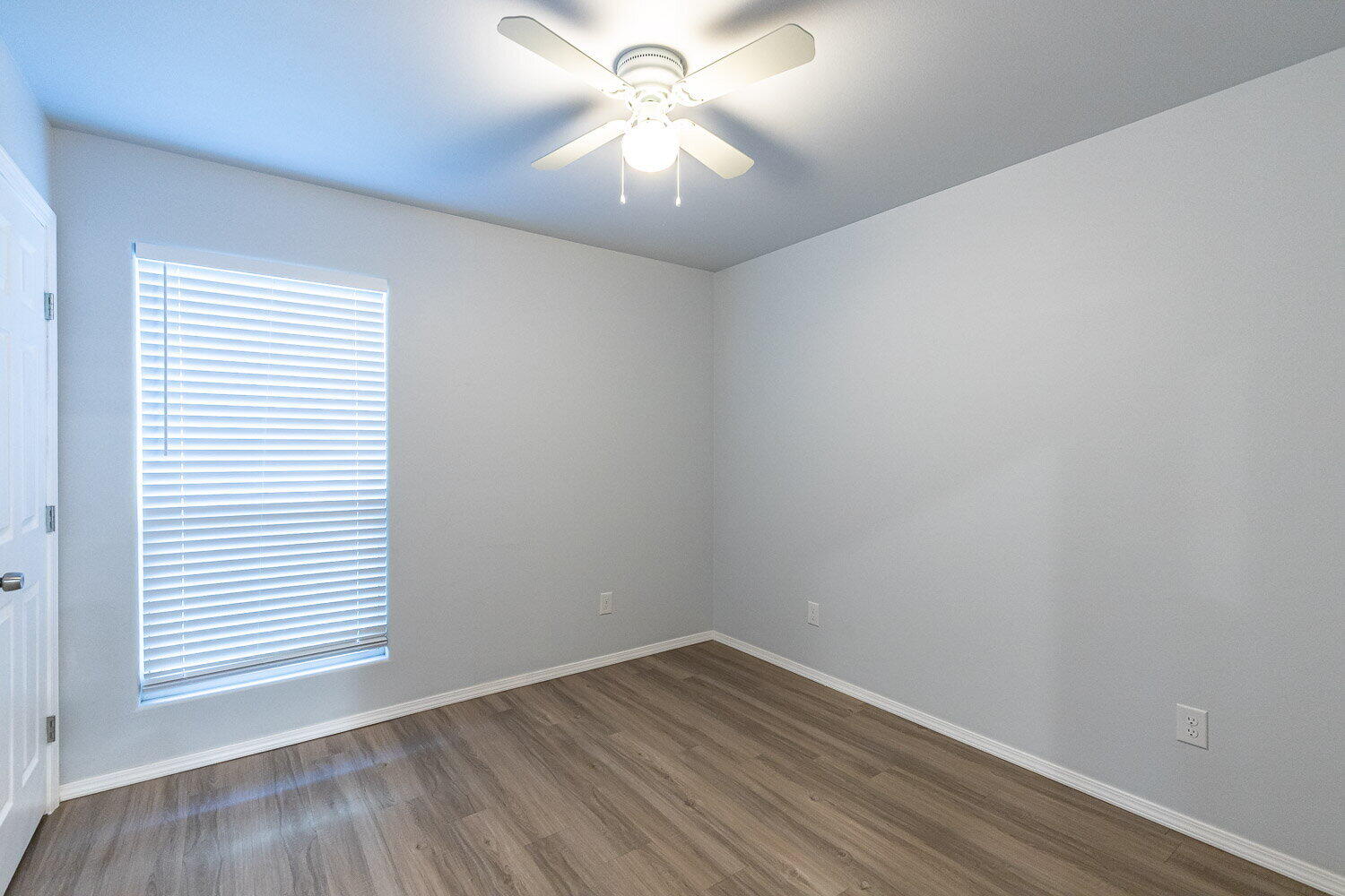 5517 Kemper Street, Unit A Lubbock, TX 79416 - Photo 23 of 25 wooden floor in an empty room with a window