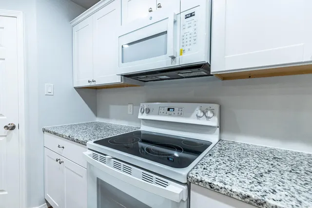 a stove top oven sitting inside of a kitchen