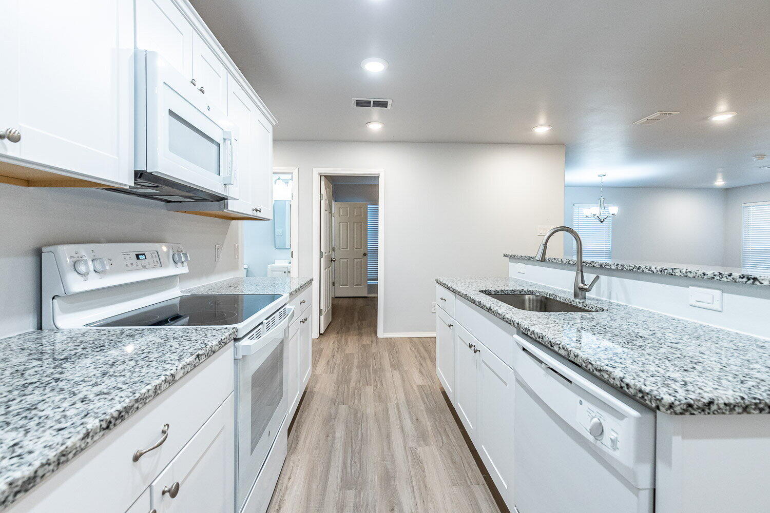 5517 Kemper Street, Unit A Lubbock, TX 79416 - Photo 5 of 25 a kitchen with stainless steel appliances granite countertop a sink stove and refrigerator
