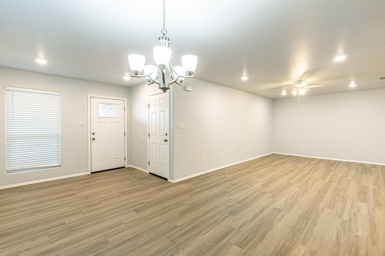 5517 Kemper Street, Unit A Lubbock, TX 79416 - Photo 8 of 25 an empty room with wooden floor and windows