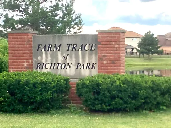 a view of a sign board with a big yard
