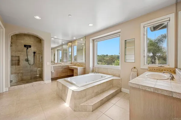 a bathroom with a granite countertop sink a toilet and a mirror