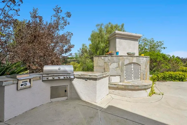 a view of a livingroom with a fireplace and chandelier