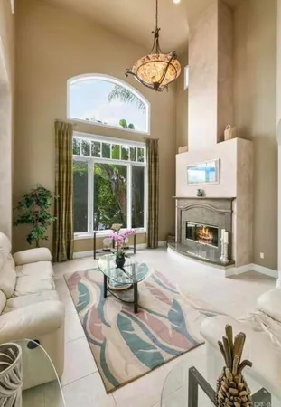 an empty room with fireplace and a ceiling fan