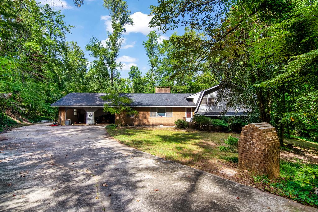 2063 Canton Road Nelson, GA 30143 - Photo 7 of 19 a front view of a house with a yard garage and outdoor seating