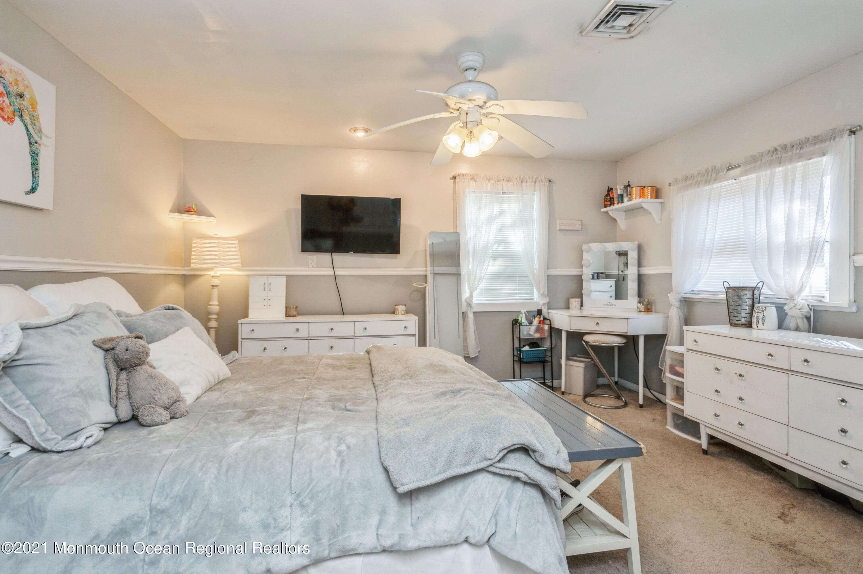 542 Lloyd Road Toms River, NJ 08753 - Photo 12 of 20 a bedroom with a large bed and a flat screen tv
