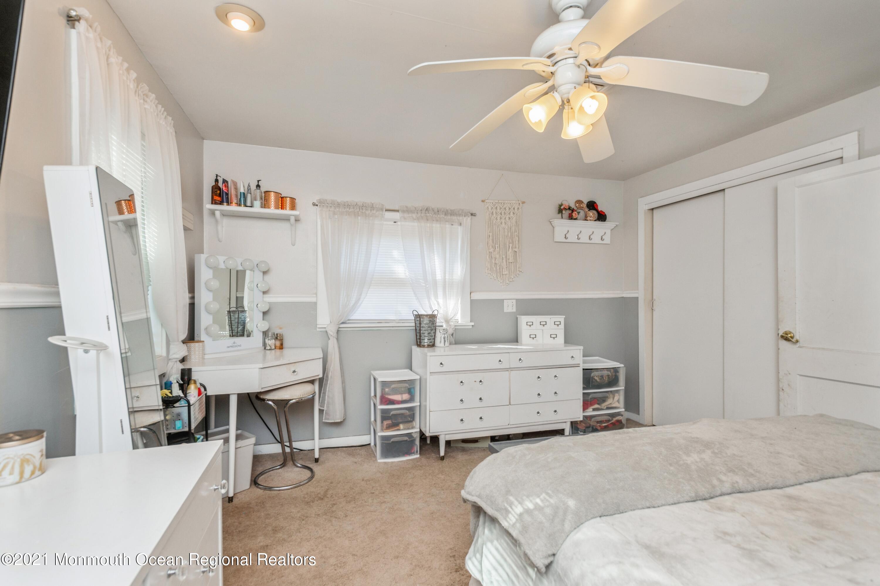 542 Lloyd Road Toms River, NJ 08753 - Photo 13 of 20 a spacious bedroom with a bed and a chandelier