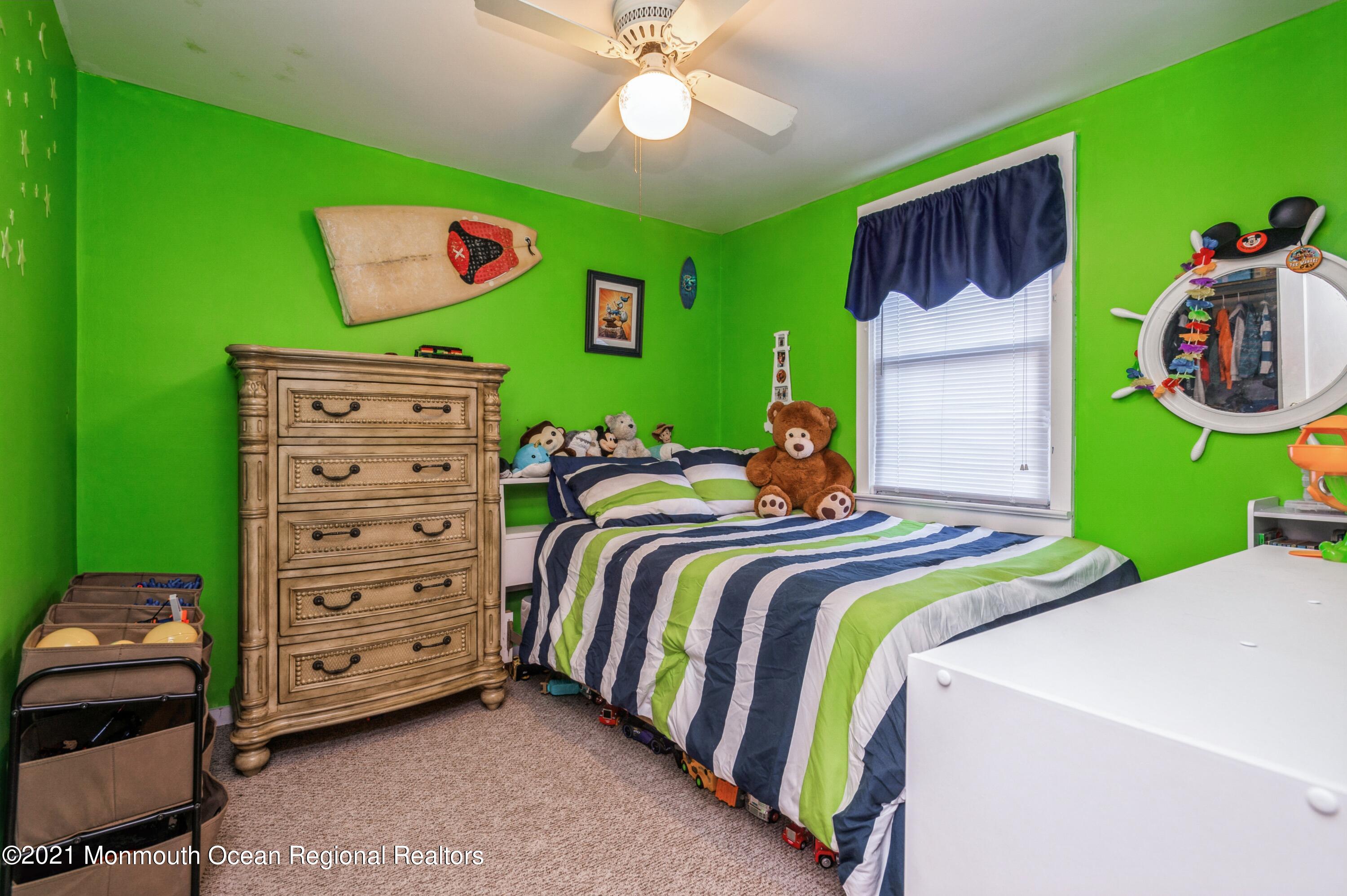 542 Lloyd Road Toms River, NJ 08753 - Photo 14 of 20 a bedroom with a bed and a chandelier