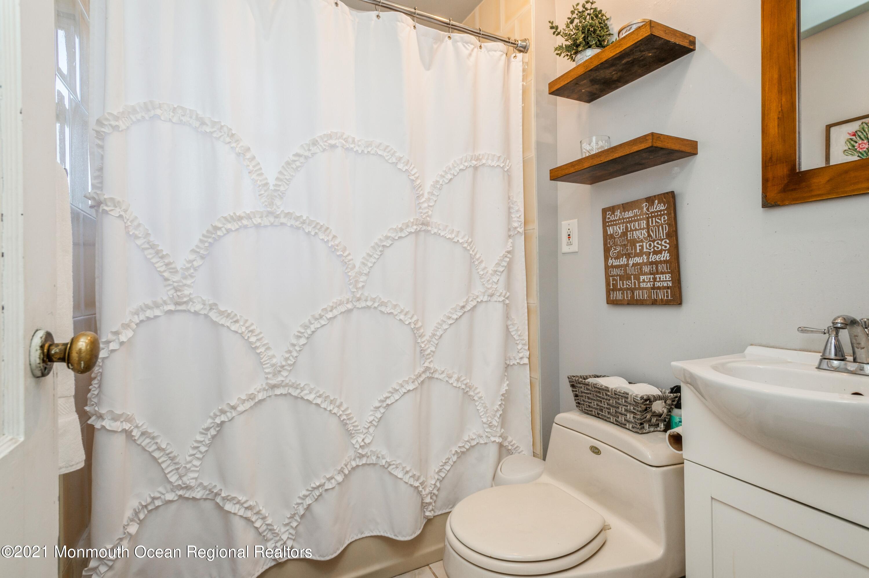 542 Lloyd Road Toms River, NJ 08753 - Photo 15 of 20 a bathroom with a toilet sink and shower