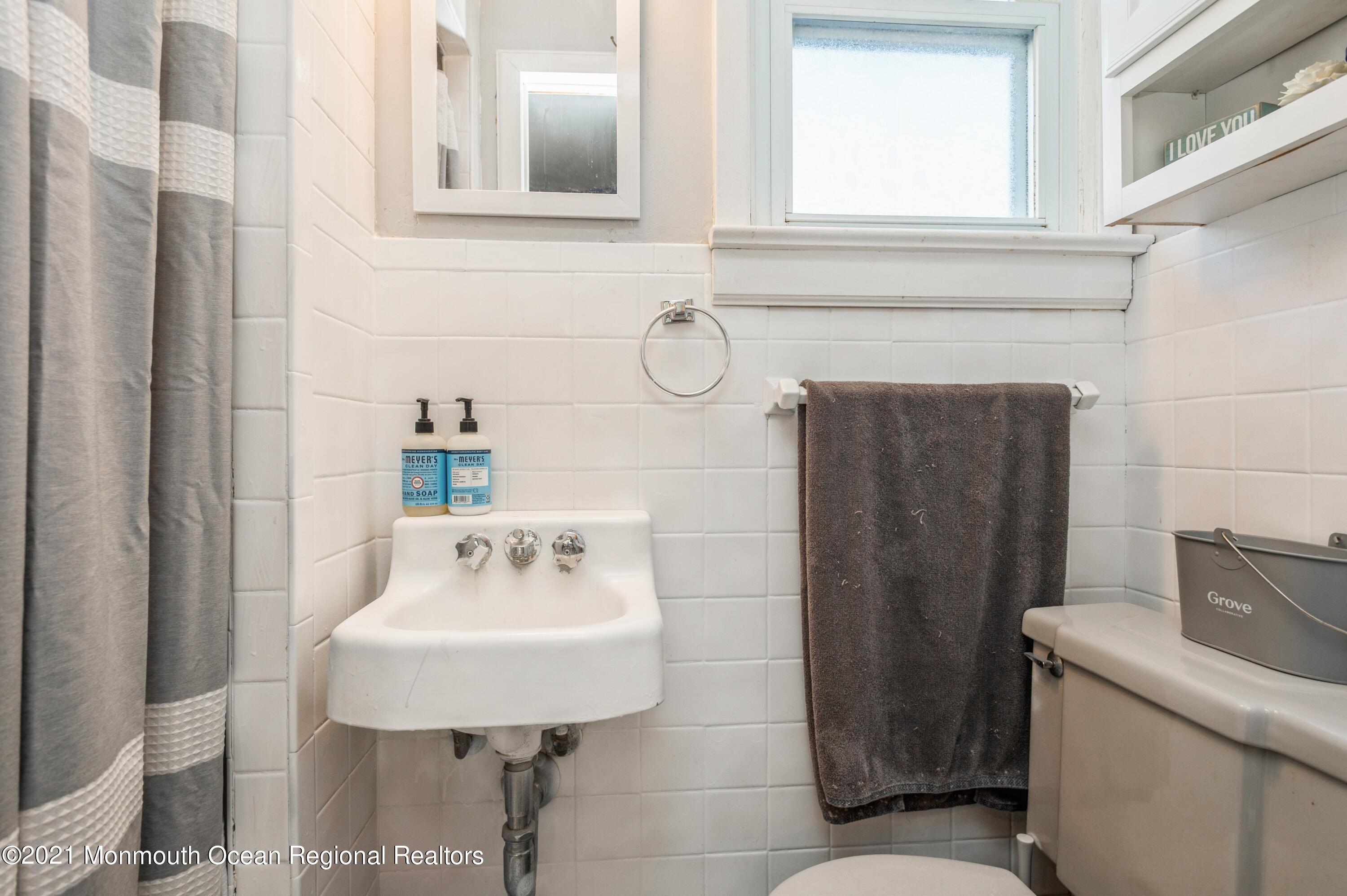 542 Lloyd Road Toms River, NJ 08753 - Photo 16 of 20 a bathroom with a sink and a mirror