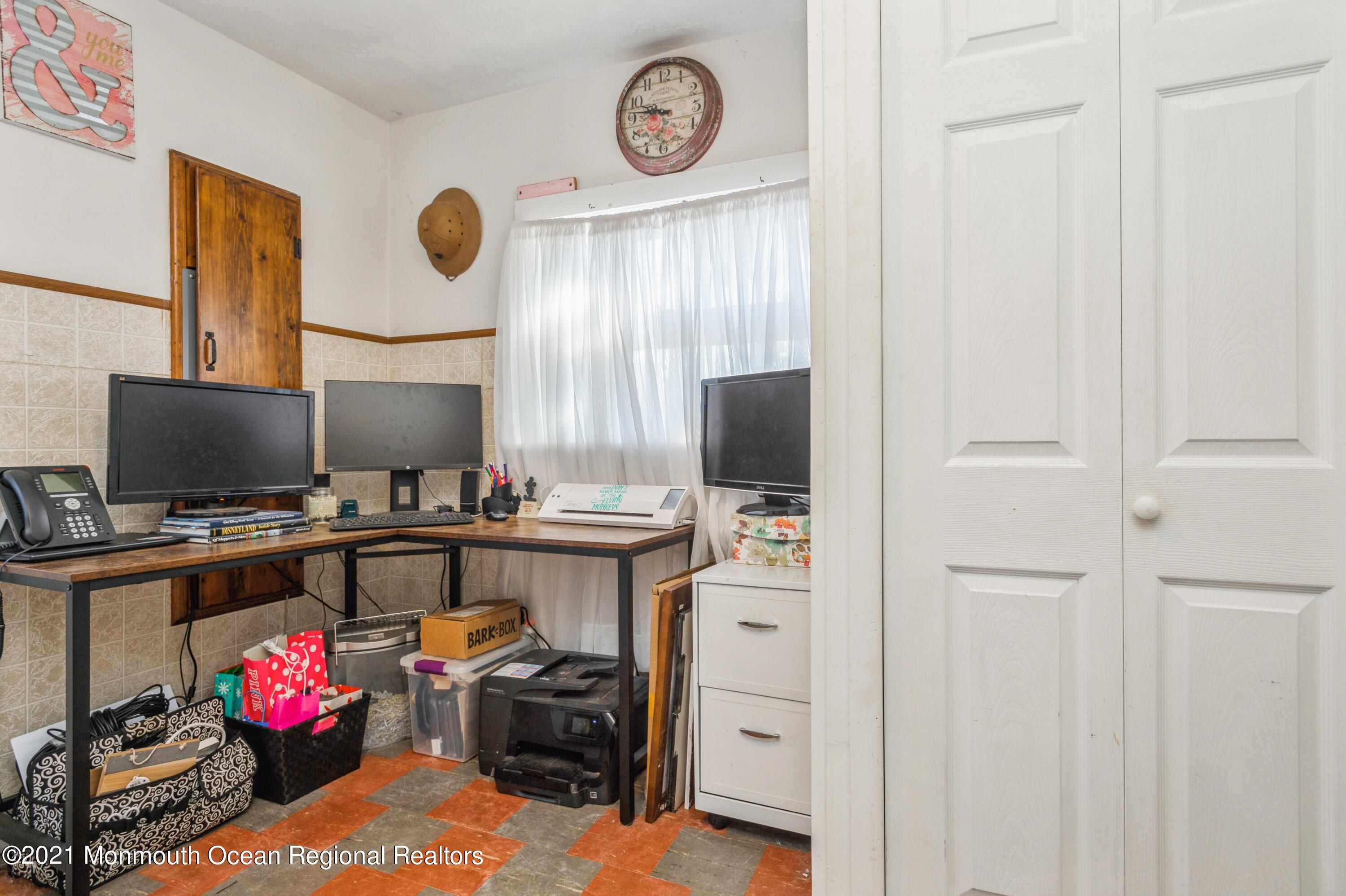 542 Lloyd Road Toms River, NJ 08753 - Photo 17 of 20 a view of a workspace with furniture and a flat screen tv