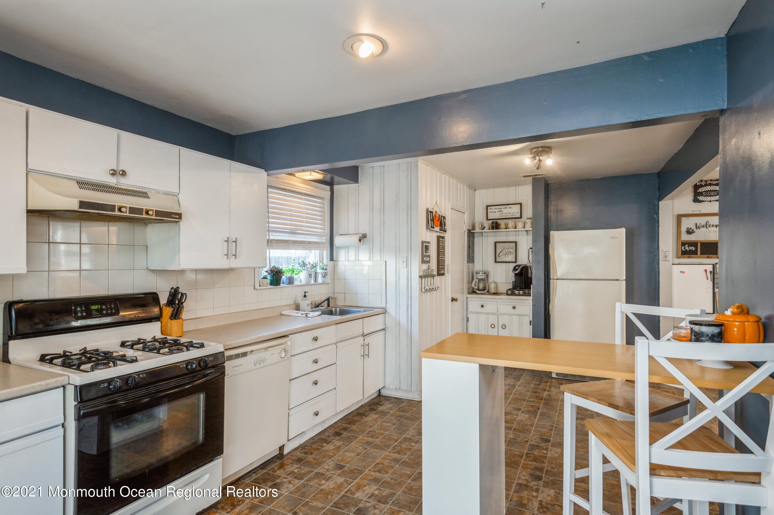 542 Lloyd Road Toms River, NJ 08753 - Photo 4 of 20 a kitchen with stainless steel appliances a stove a sink and white cabinets