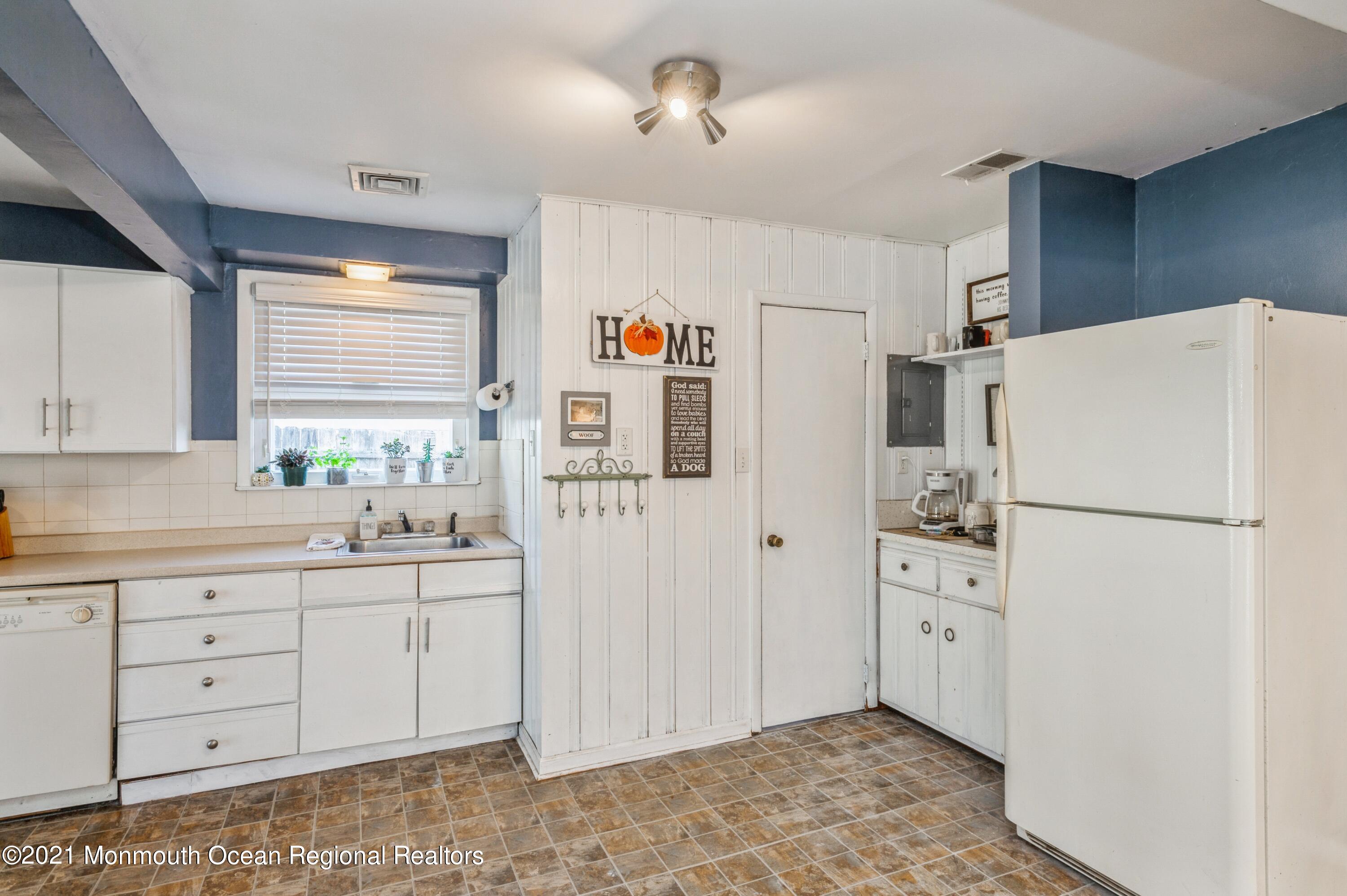 542 Lloyd Road Toms River, NJ 08753 - Photo 5 of 20 a kitchen with white cabinets and white appliances
