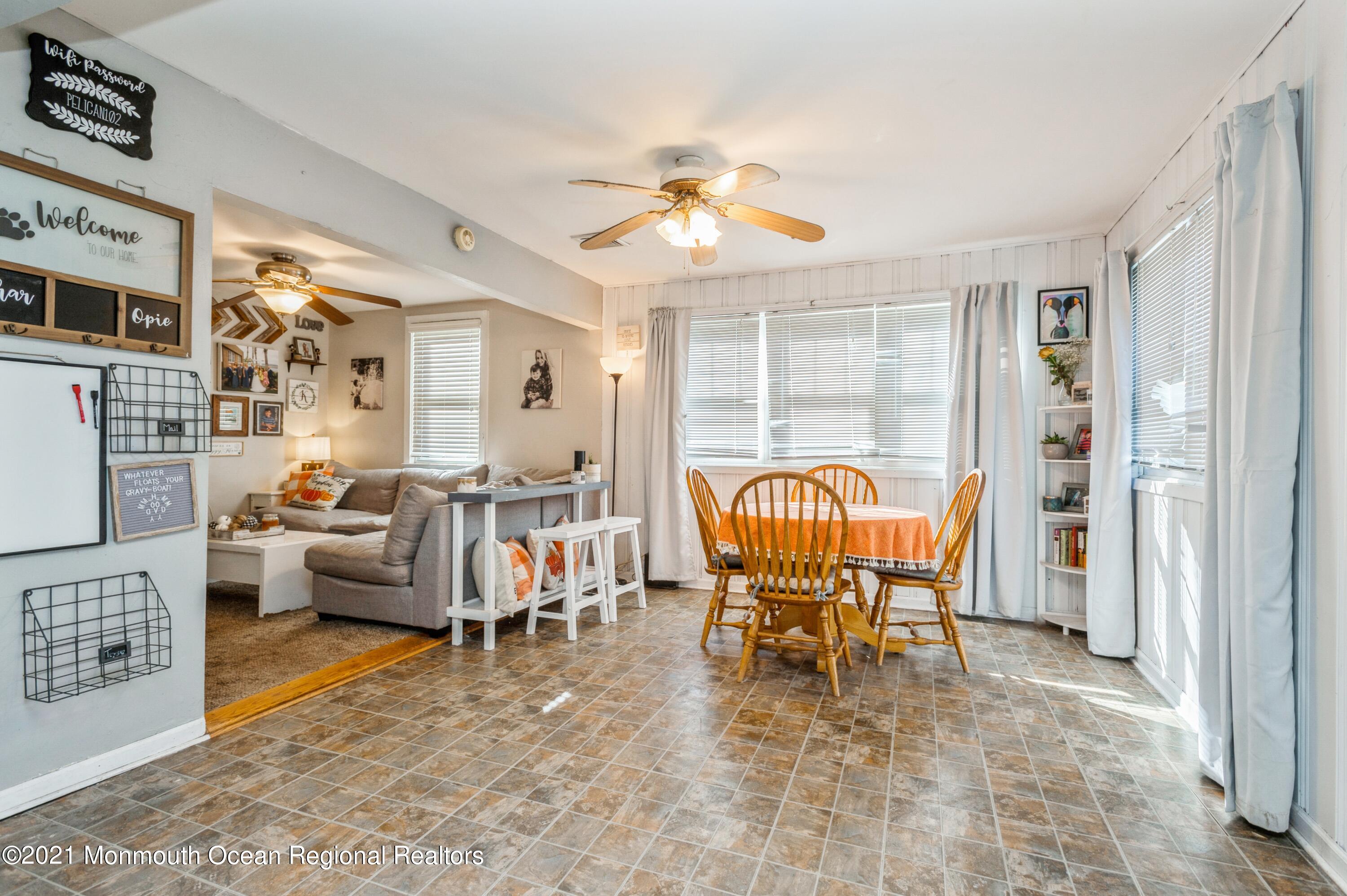 542 Lloyd Road Toms River, NJ 08753 - Photo 6 of 20 a living room with furniture a chandelier and a dining table