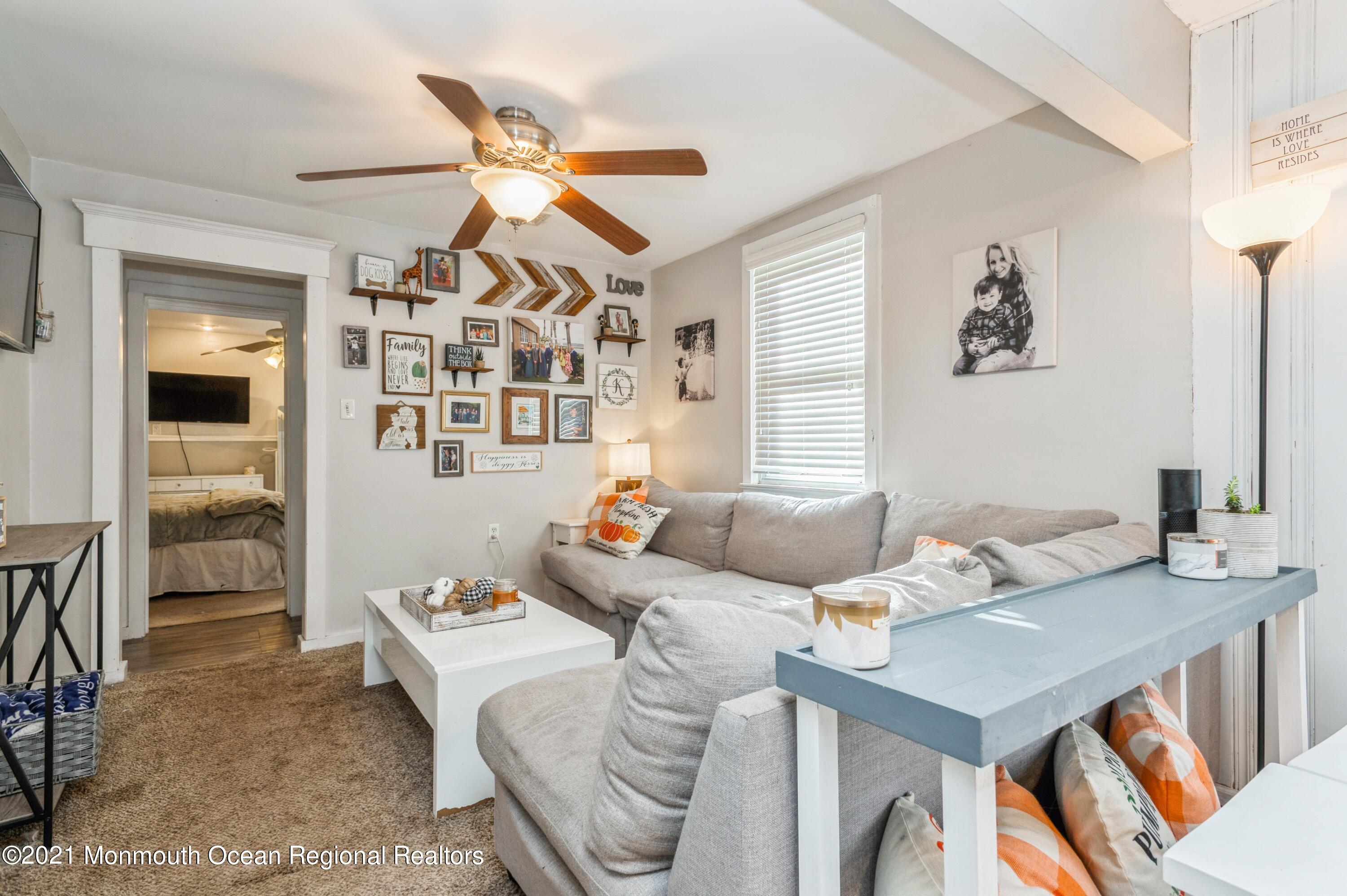 542 Lloyd Road Toms River, NJ 08753 - Photo 10 of 20 a living room with furniture a chandelier and a dining table