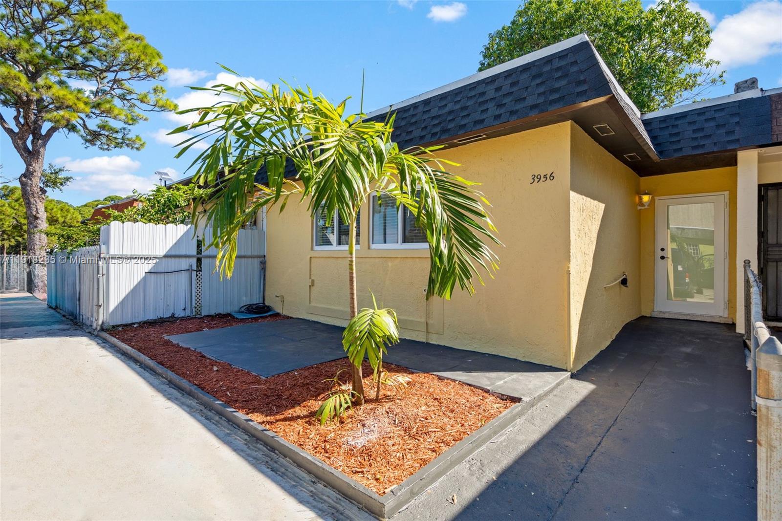 3956 Northwest 207 St Road Miami Gardens, FL 33055 - Photo 1 of 36 a front view of house with yard