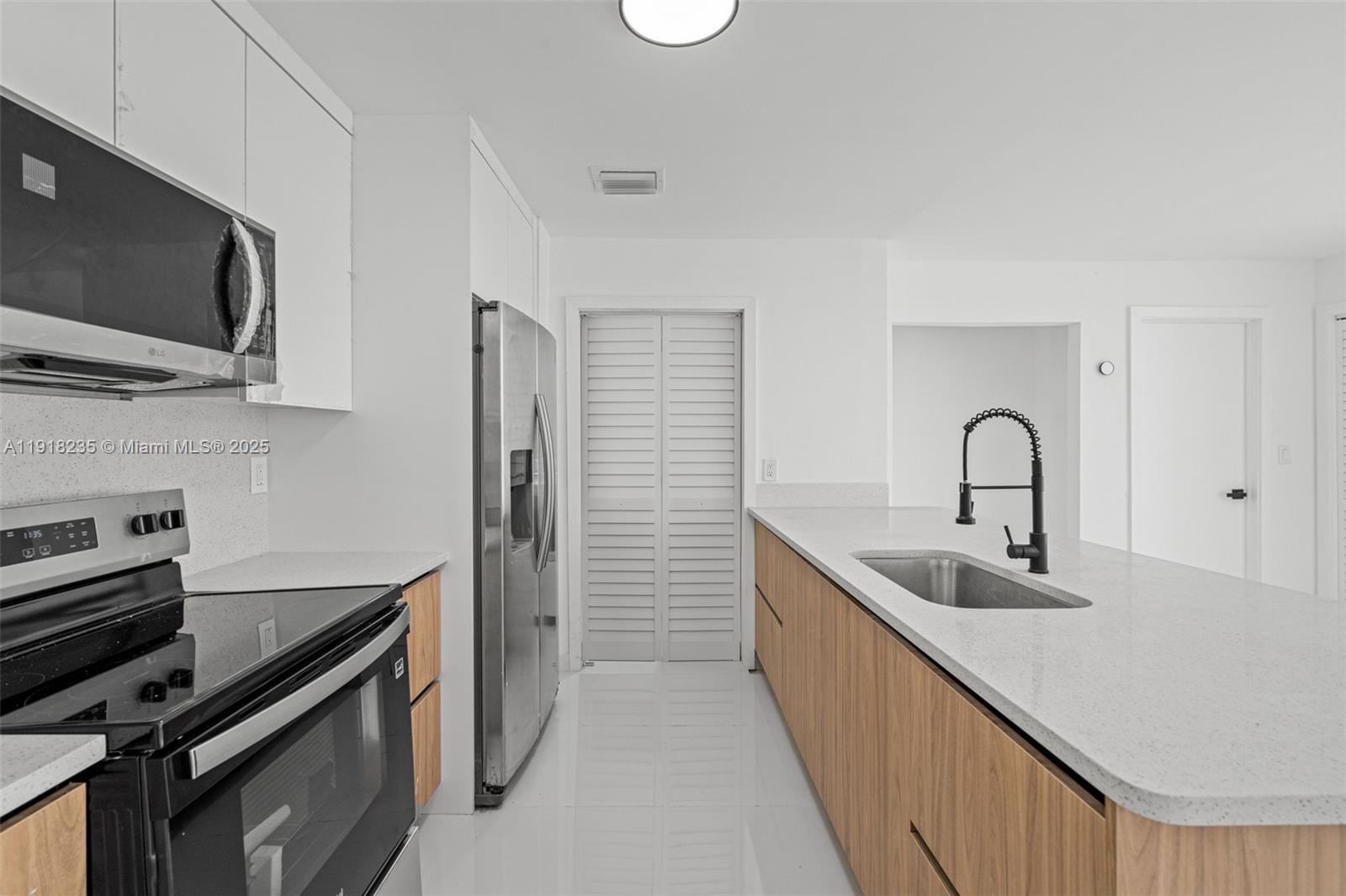 3956 Northwest 207 St Road Miami Gardens, FL 33055 - Photo 13 of 36 a kitchen with stainless steel appliances and a sink