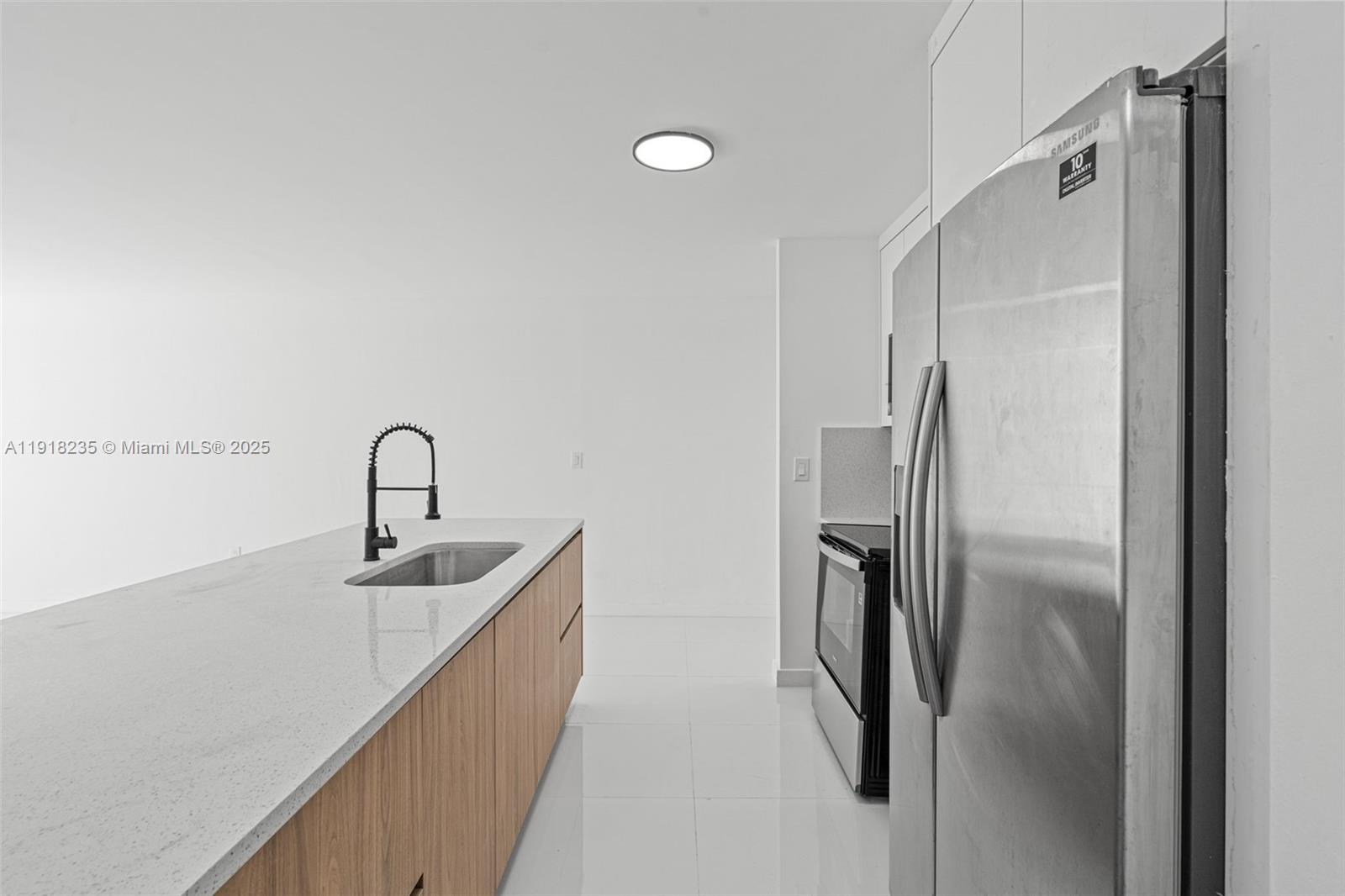 3956 Northwest 207 St Road Miami Gardens, FL 33055 - Photo 14 of 36 a kitchen with stainless steel appliances granite countertop a refrigerator and a sink