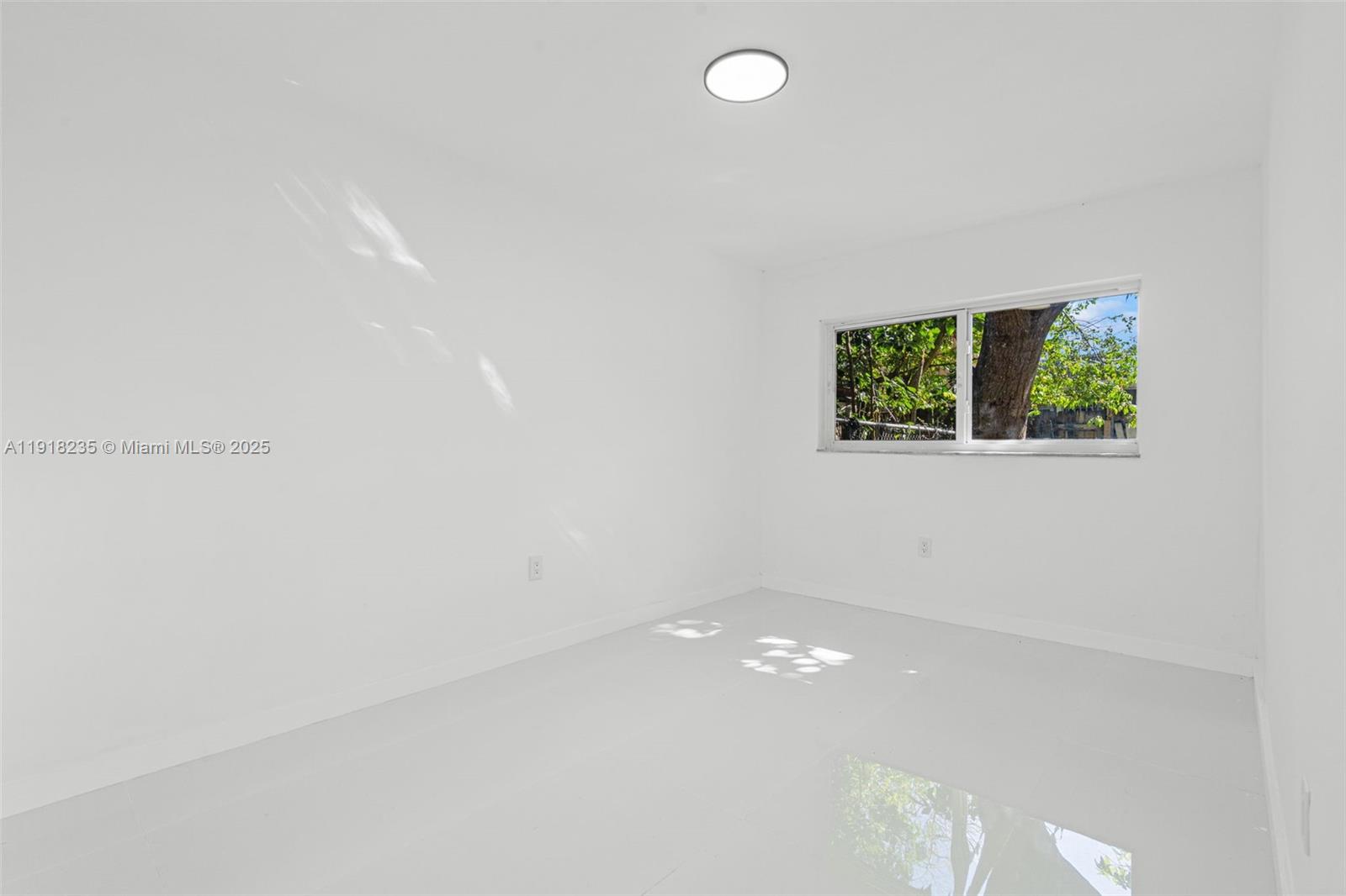 3956 Northwest 207 St Road Miami Gardens, FL 33055 - Photo 18 of 36 an empty room with windows