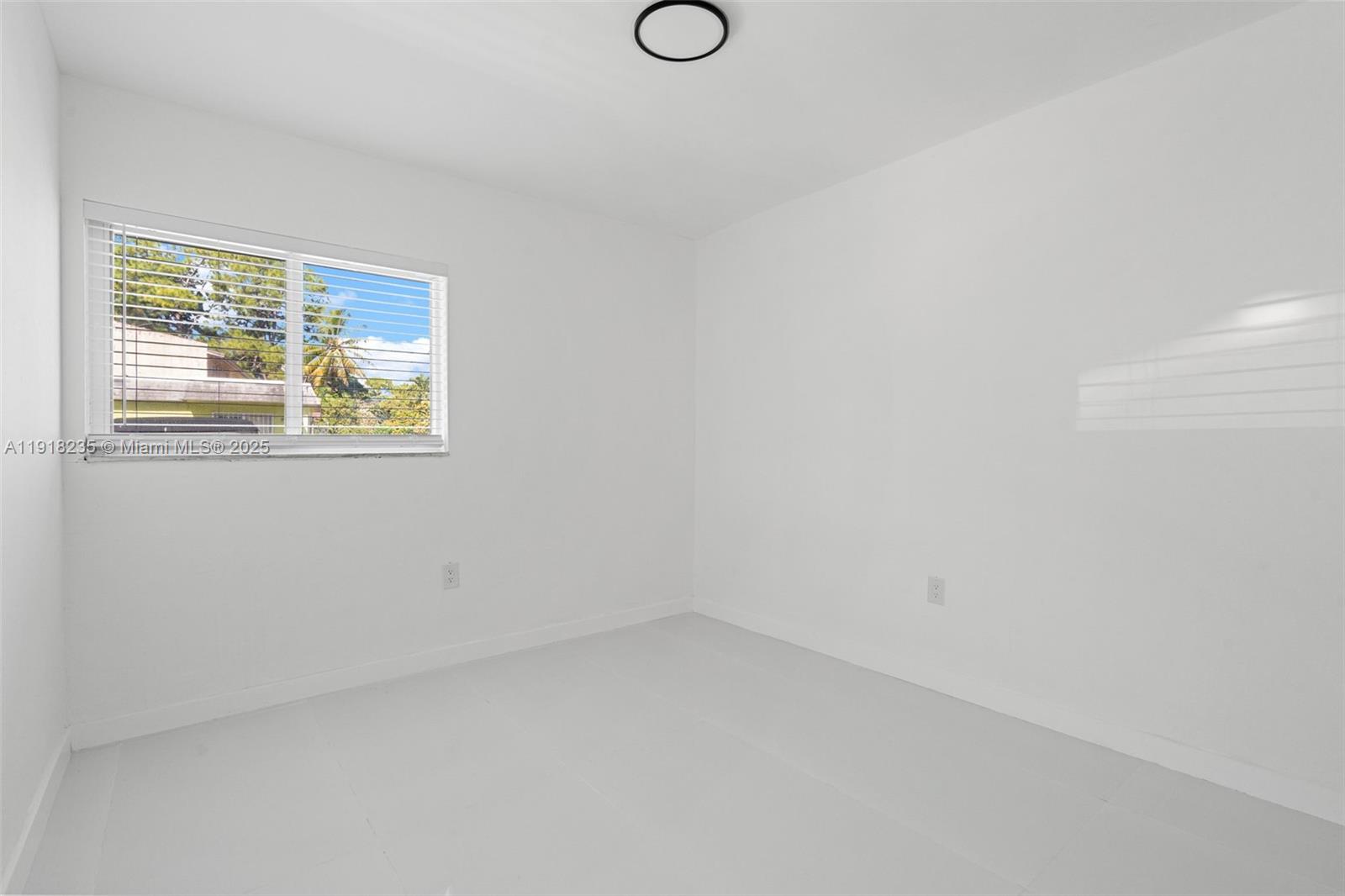 3956 Northwest 207 St Road Miami Gardens, FL 33055 - Photo 27 of 36 a view of an empty room with wooden floor and windows