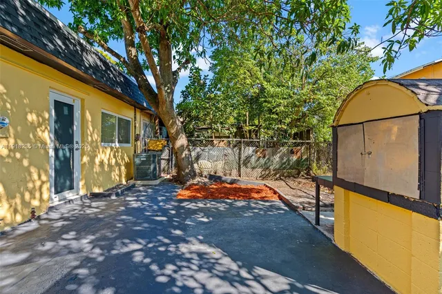 a backyard of a house with a tree