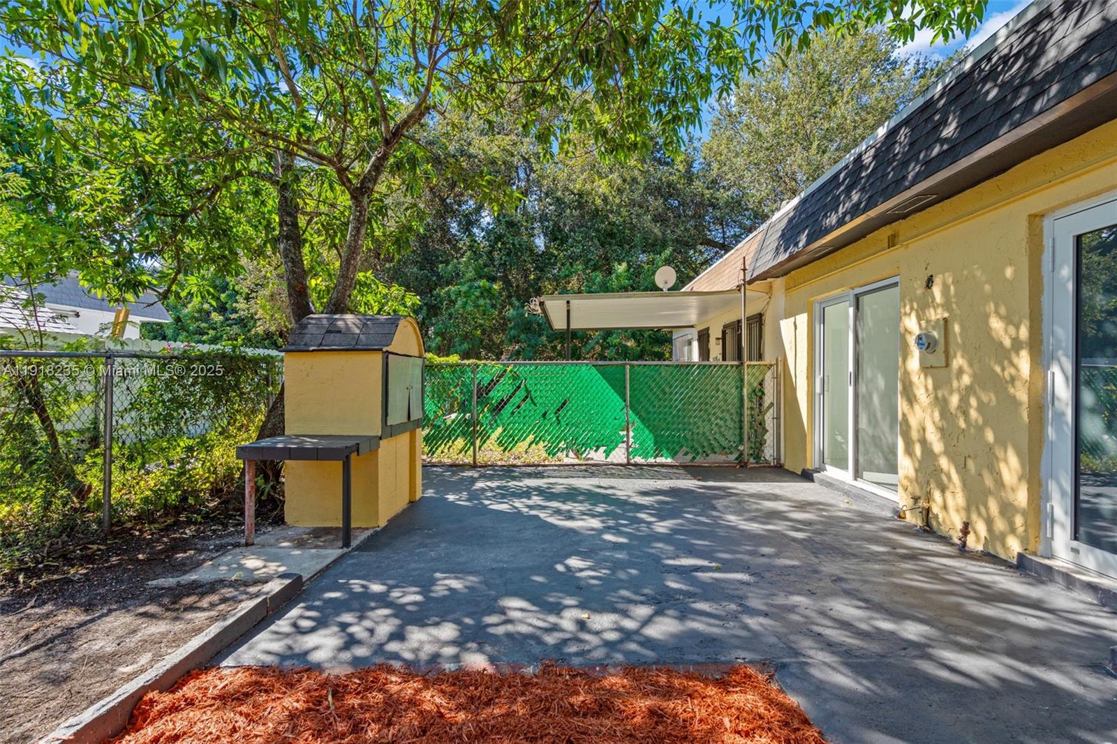 3956 Northwest 207 St Road Miami Gardens, FL 33055 - Photo 33 of 36 a backyard of a house with outdoor seating