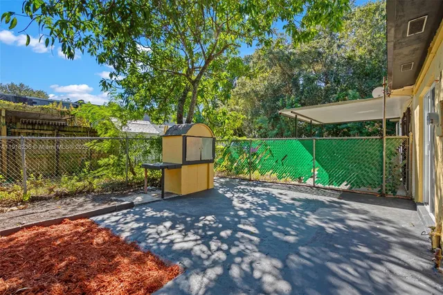 a view of a park with a bench and trees