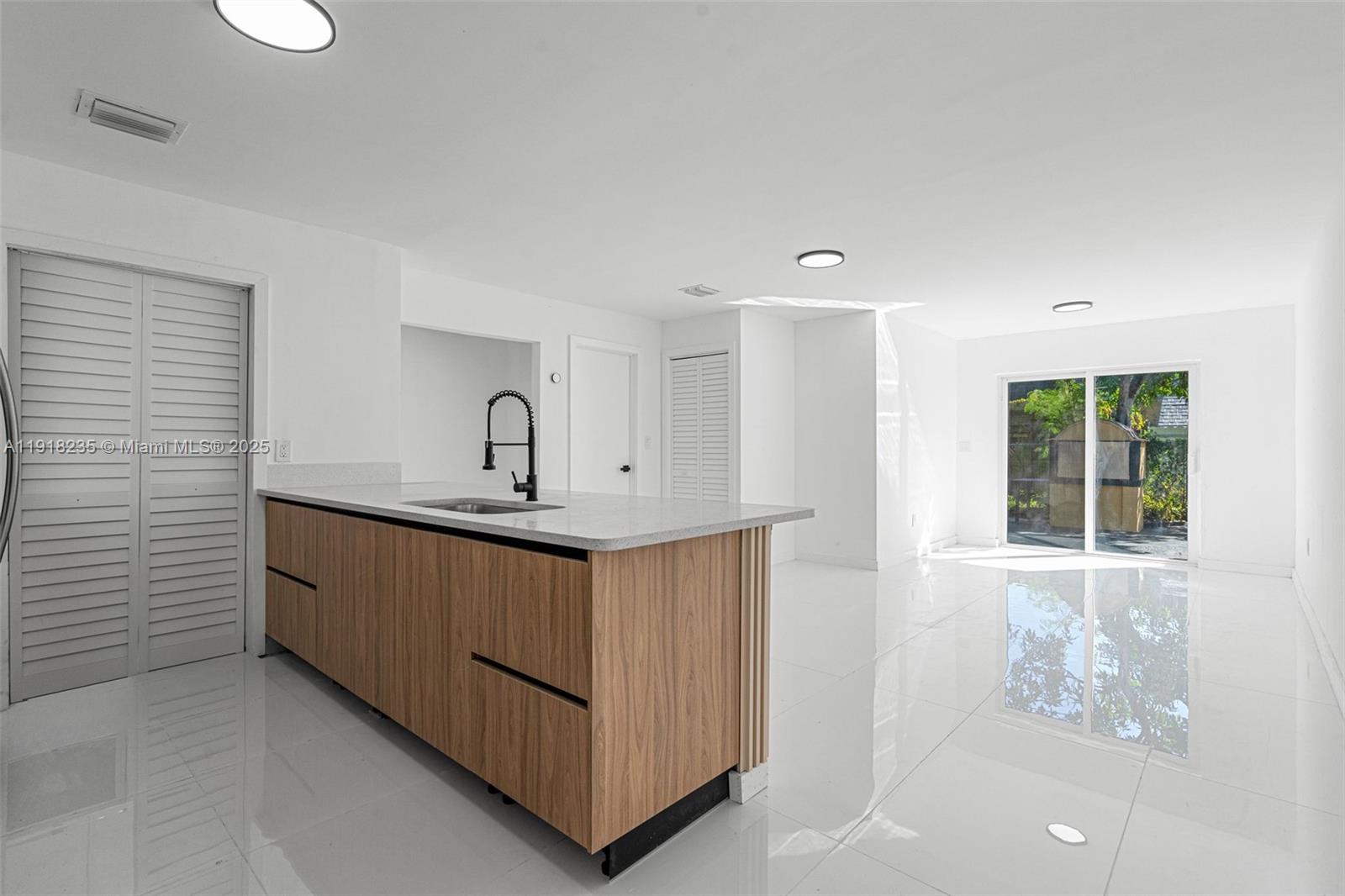 3956 Northwest 207 St Road Miami Gardens, FL 33055 - Photo 5 of 36 a room with a sink a window and chandelier