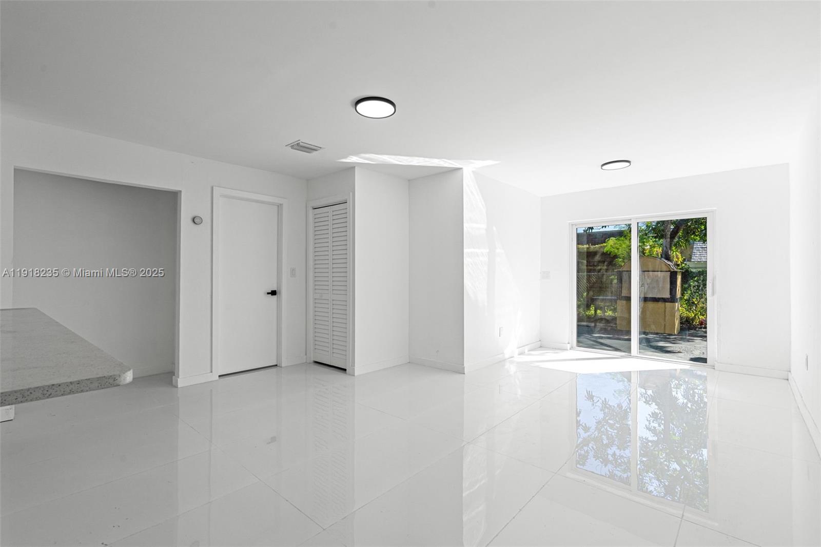 3956 Northwest 207 St Road Miami Gardens, FL 33055 - Photo 6 of 36 a view of an empty room with a window