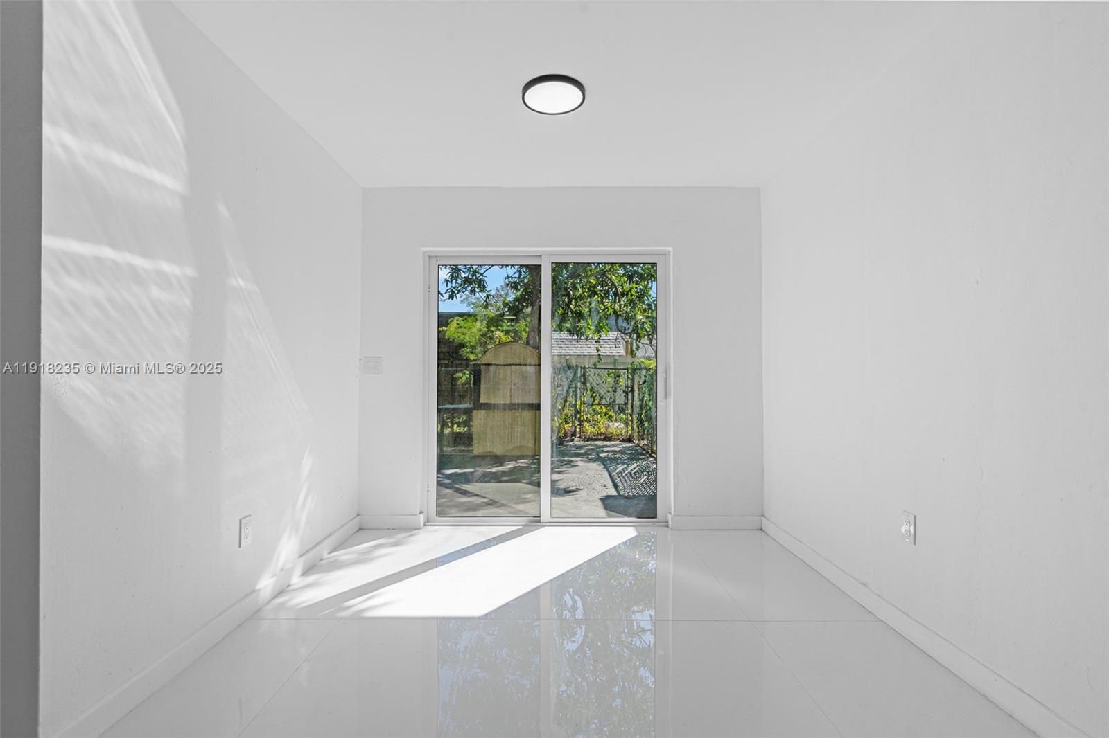 3956 Northwest 207 St Road Miami Gardens, FL 33055 - Photo 7 of 36 a view of an empty room with a window