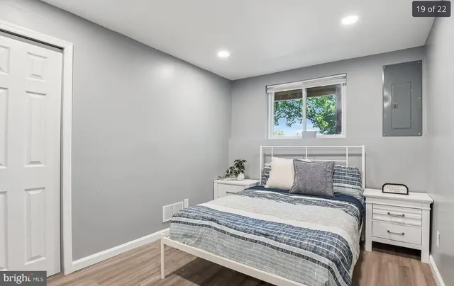 a bedroom with a bed and a window