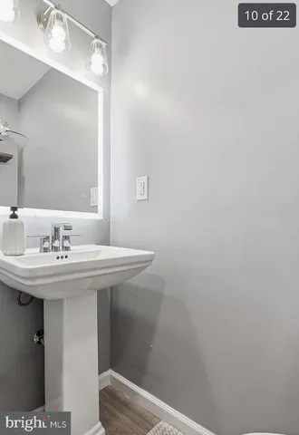 a bathroom with a sink a toilet and mirror