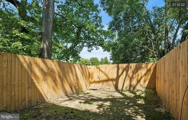a view of a yard with wooden fence