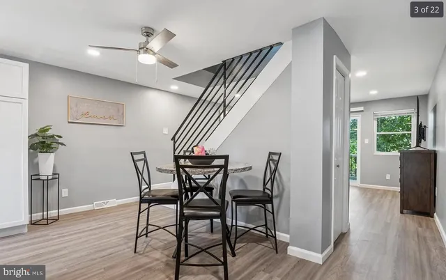 a view of a dining room with furniture and wooden floor