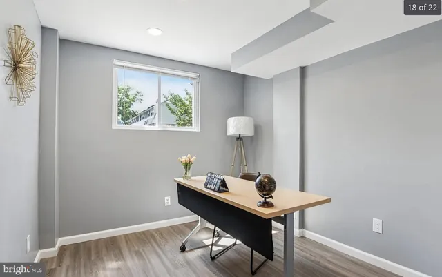 a view of a workspace with furniture and wooden floor