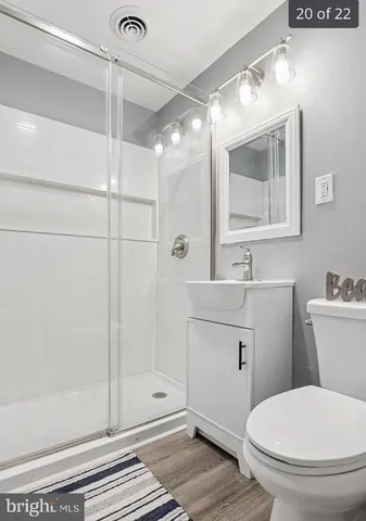 a bathroom with a toilet a sink and shower