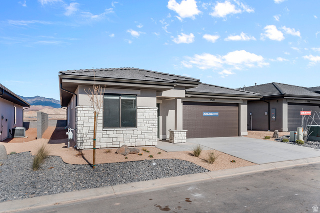 1589 South Fins Road, Unit 4178 Washington, UT 84780 - Photo 3 of 30 Contemporary single-story residence featuring a stone and stucco facade, a dark shingle roof, and an attached two-car garage