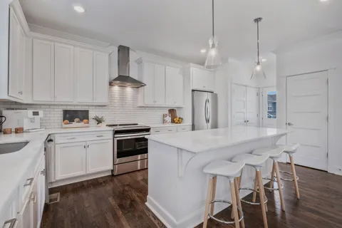 a kitchen with a stove a sink and a refrigerator