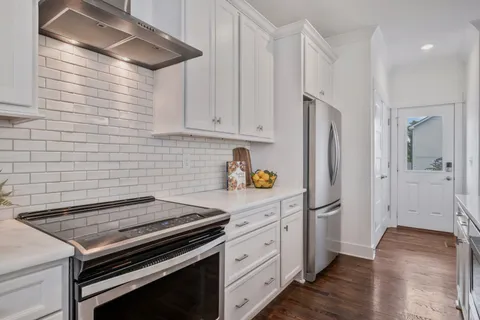 a kitchen with stainless steel appliances a stove a refrigerator and cabinets