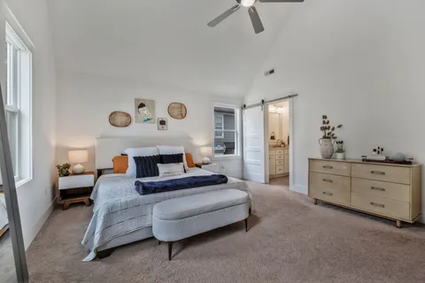 a spacious bedroom with a bed and a dresser