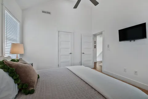a bedroom with a bed and flat screen tv