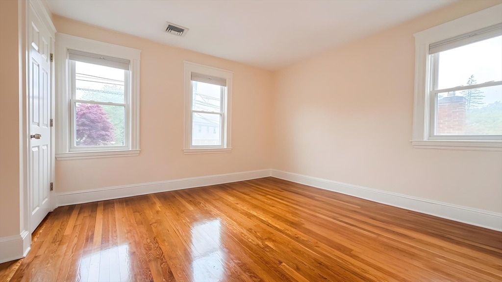 114 Curve Street Dedham, MA 02026 - Photo 17 of 27 an empty room with wooden floor and windows