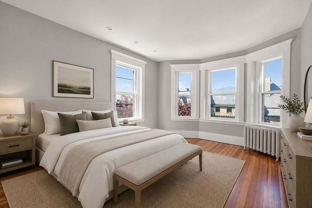 16 Garrison Road, Unit 5 Brookline, MA 02445 - Photo 7 of 14 a spacious bedroom with a bed and a large window