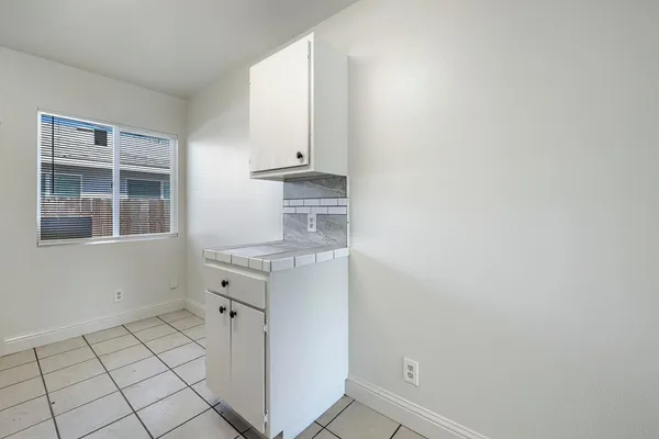 a room with a sink cabinets and utility room