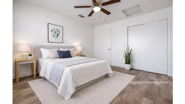 a bedroom with a bed and a chandelier