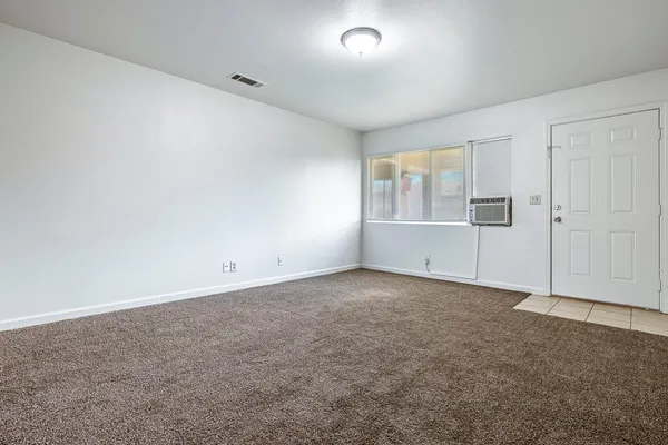 an empty room with a empty space and windows