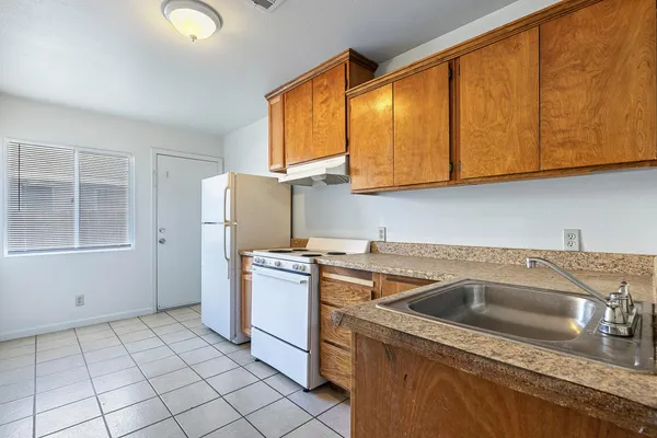 a kitchen with stainless steel appliances granite countertop a sink and cabinets