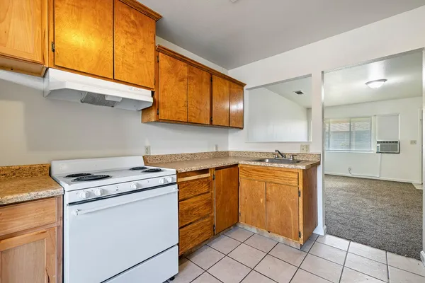 a kitchen with a sink a refrigerator and cabinets