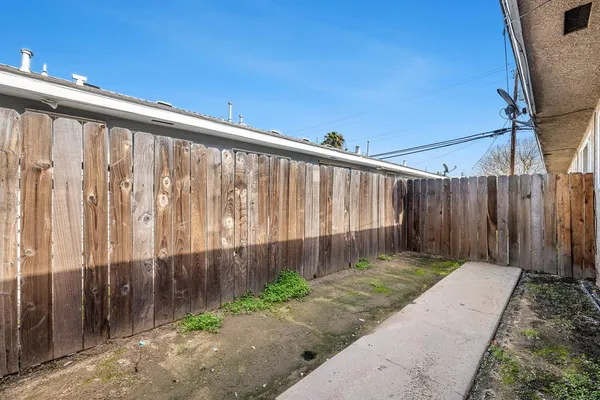 a view of a pathway of a wooden fence